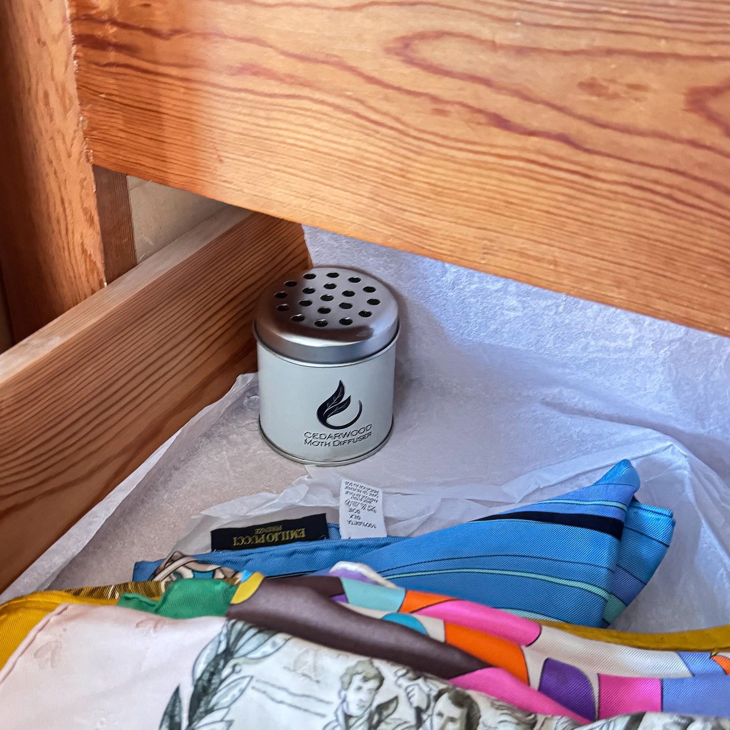 cedarwood moth repellent diffuser tin in a drawer with silk scarves